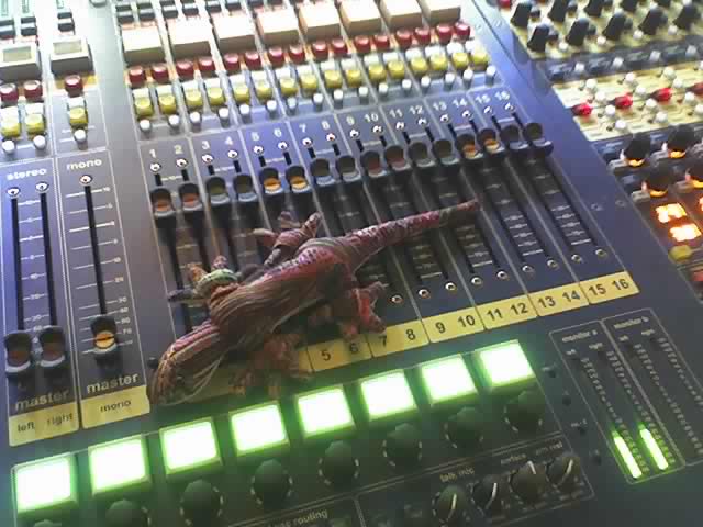 Stuffed lizard on a sound board.
